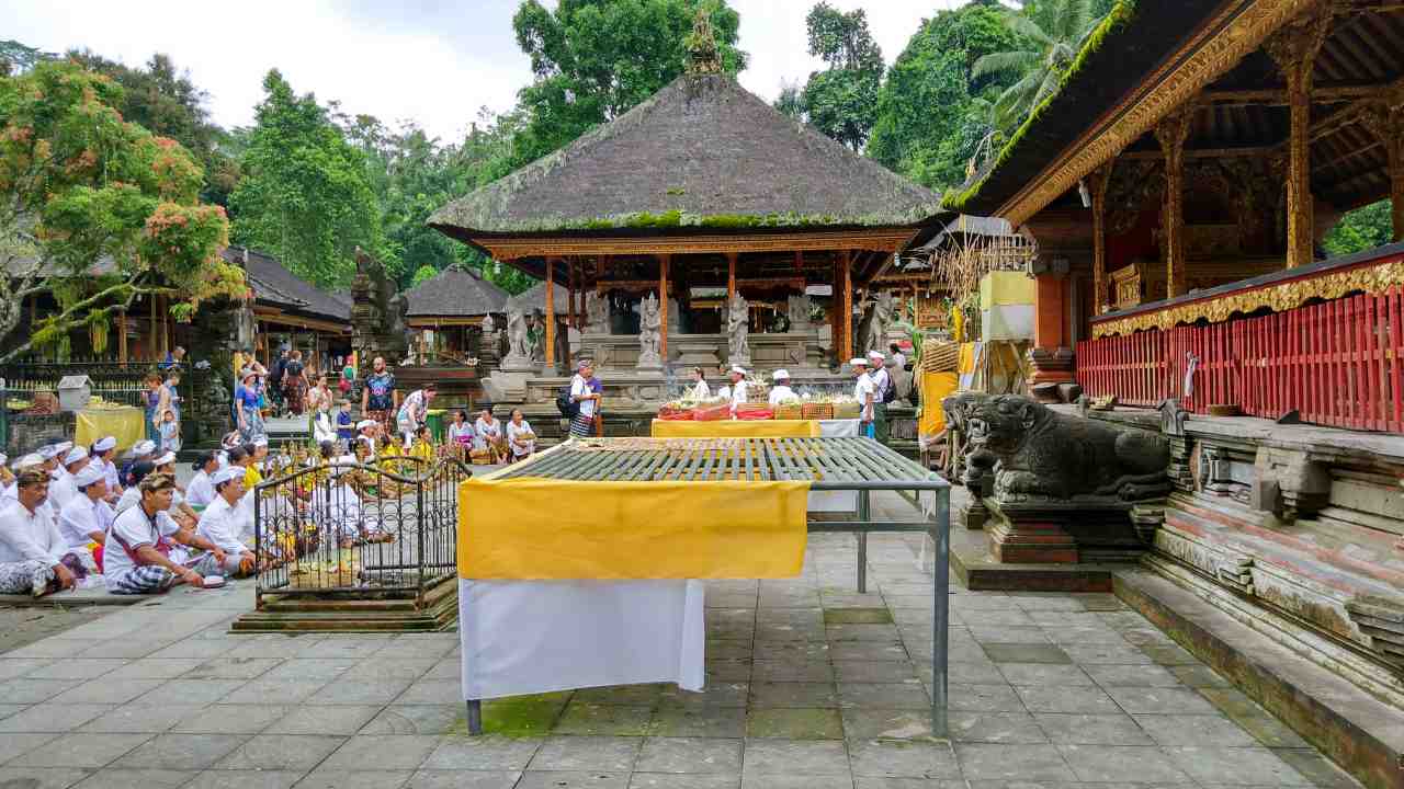 locals praying at tirta empul temple 